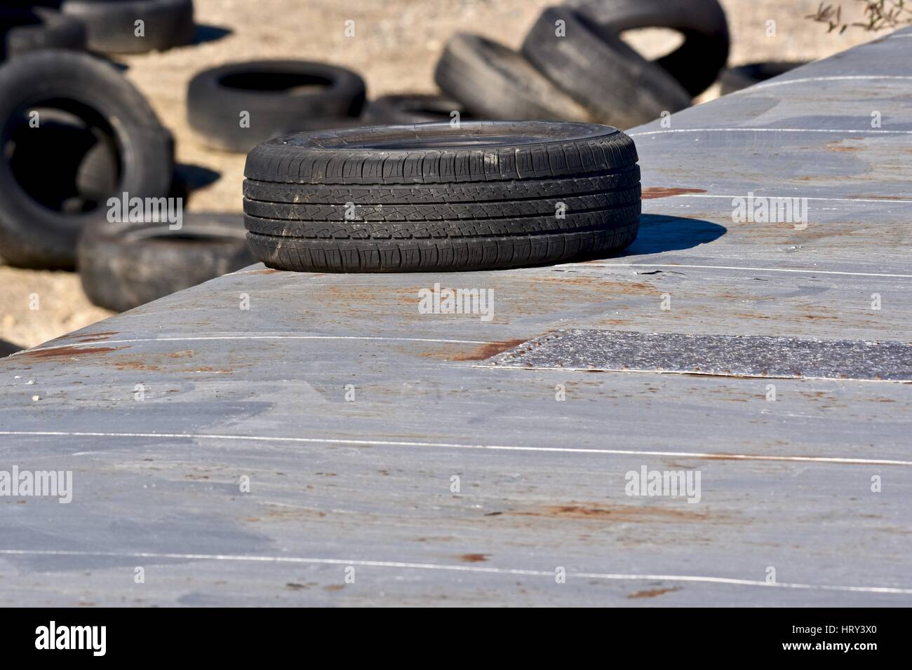 Pile of used tires in a junk yard Stock Photo