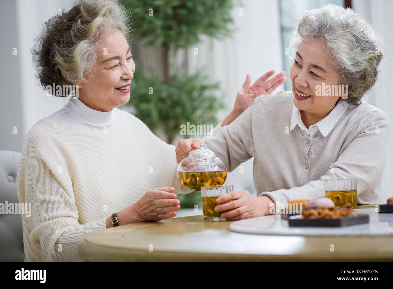 Happy senior women talking and drinking tea Stock Photo - Alamy