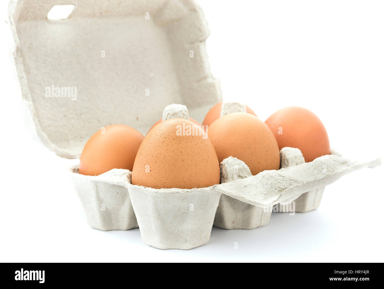 Brown chicken eggs in an open cardboard  carton. Stock Photo
