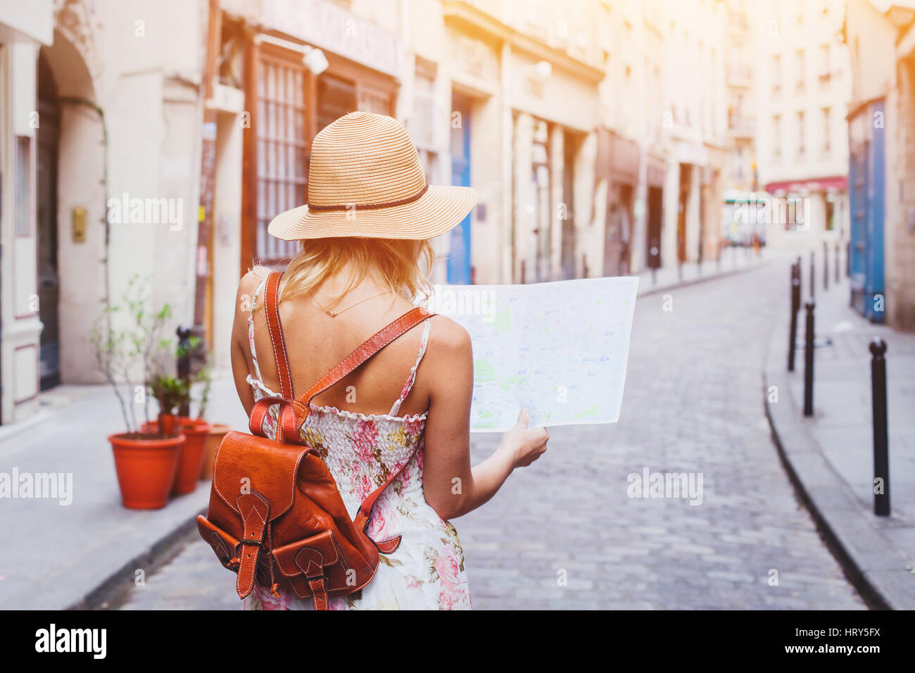 woman tourist looking at the map on the street of european city, travel to Europe Stock Photo
