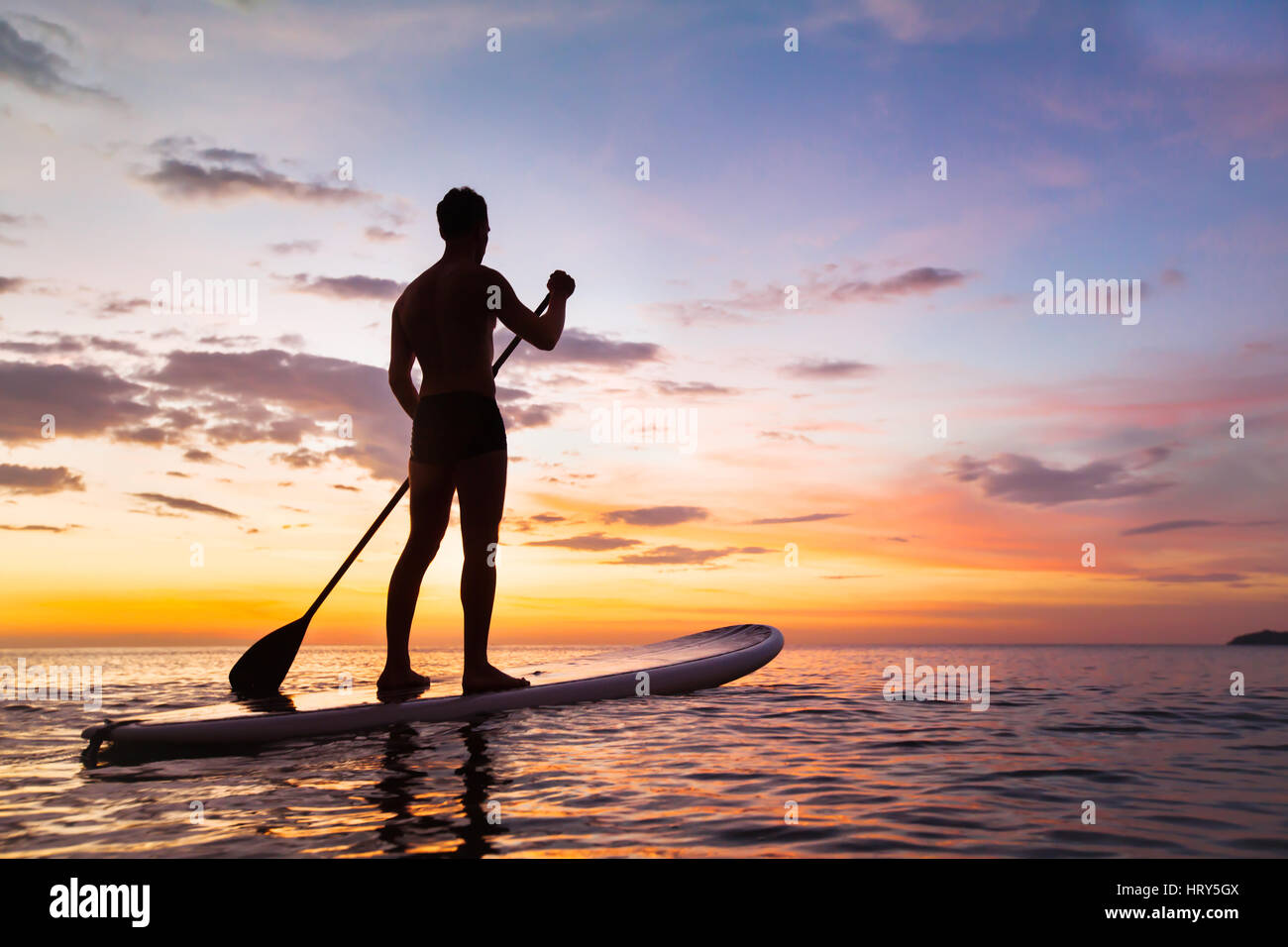 paddleboard on the beach at sunset, paddle standing in Thailand Stock Photo