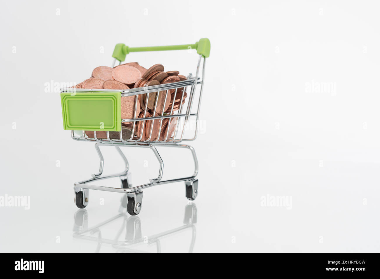 Penny / 1p coins in shopping trolley. Representing UK consumer spending power and high street sales, pennies. Stock Photo