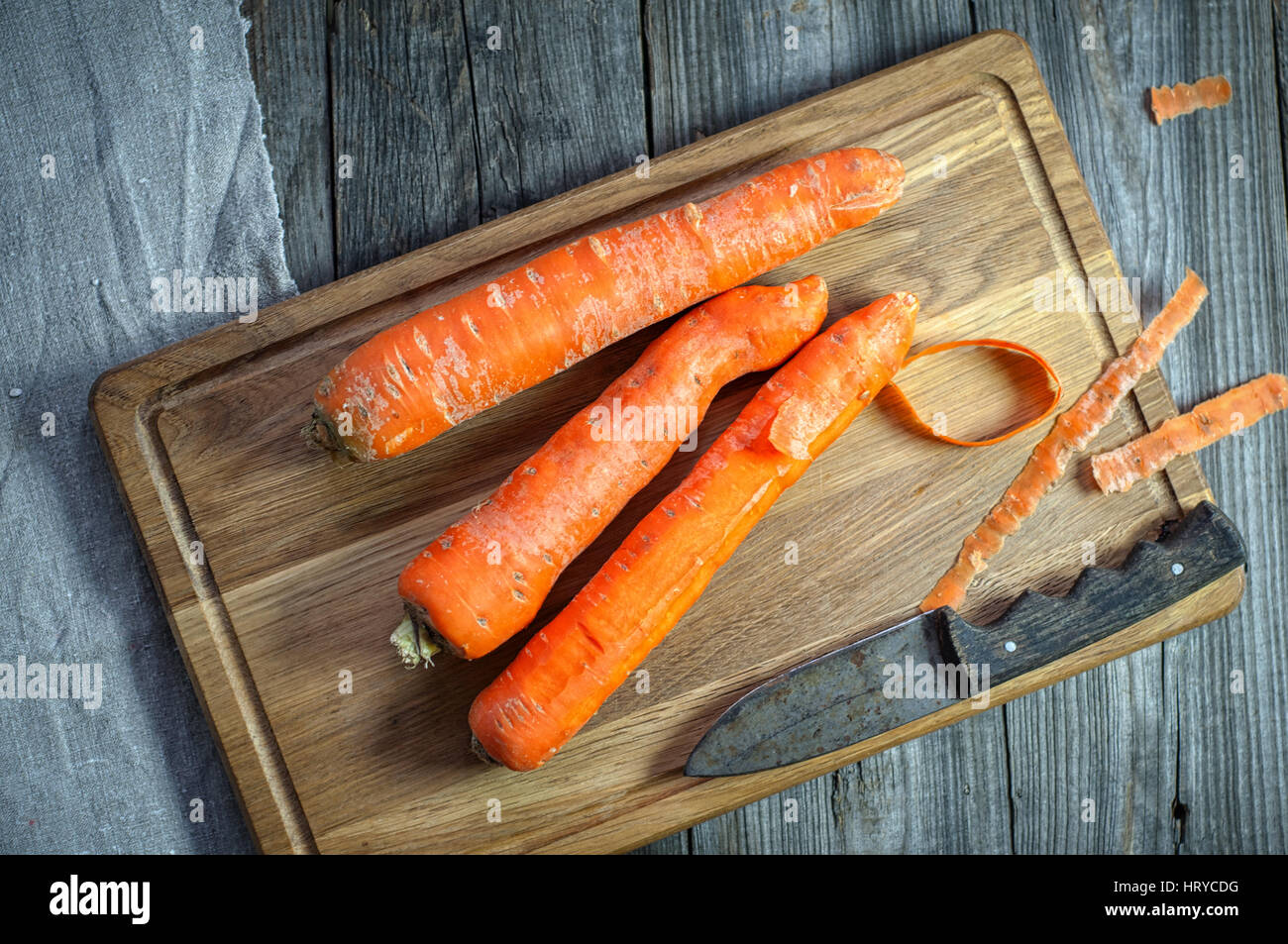 whole carrots on a kitchen wooden board, top view Stock Photo
