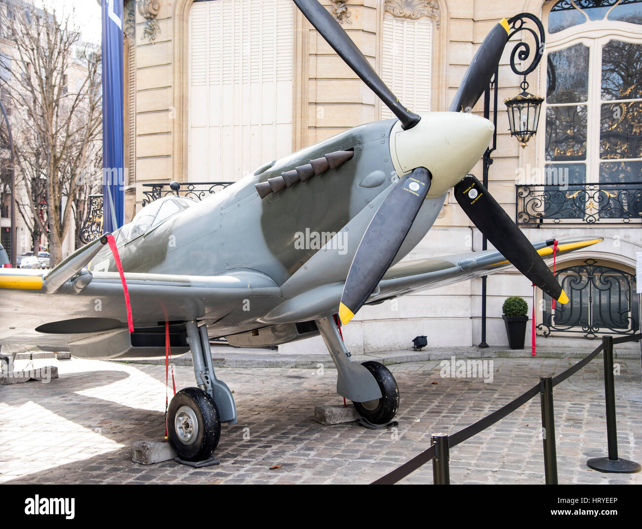 A small propellor powered fighter plane outside a building in Paris France. Stock Photo