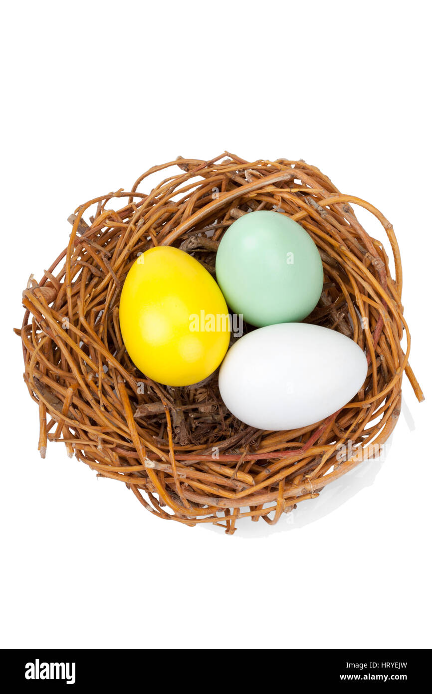 Three Easter egggs in a bird nest isolated on white background Stock ...