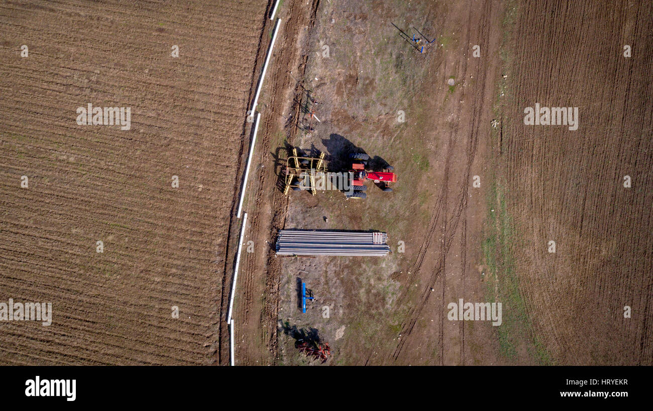 Farm with irrigation pipes and old tractor as seen from above Stock ...