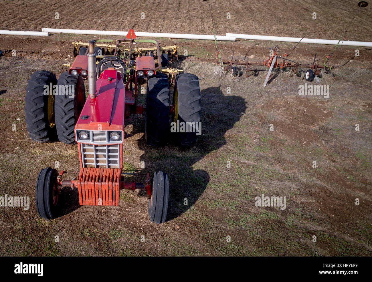 Old metal tractor and field rake in a farmers field Stock Photo - Alamy