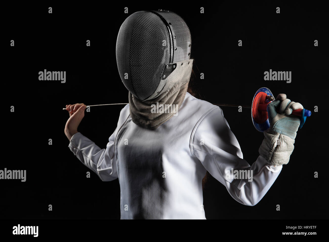 Portrait of fencer woman wearing white fencing costume. Isolated on