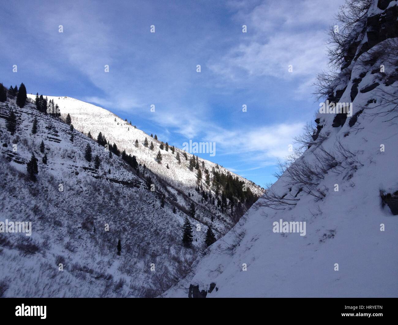 Snow covered Wasatch Mountains in the winter.  Blue skies and cirrus clouds.  Sundance, Utah, Utah County. Stock Photo