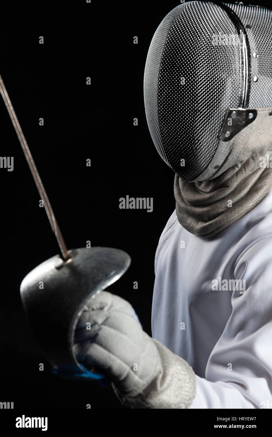 Portrait of fencer woman wearing white fencing costume. Isolated on