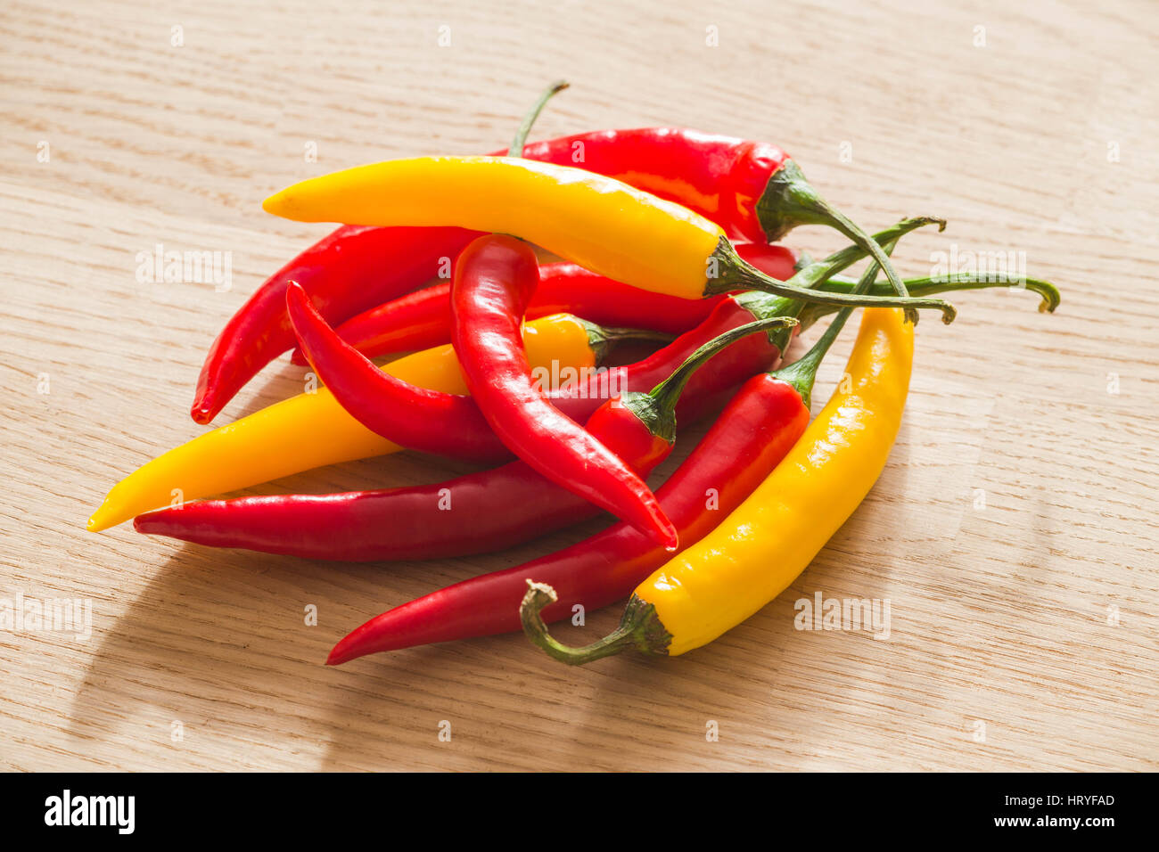 Colorful hot paprika on a light wooden table Stock Photo Alamy