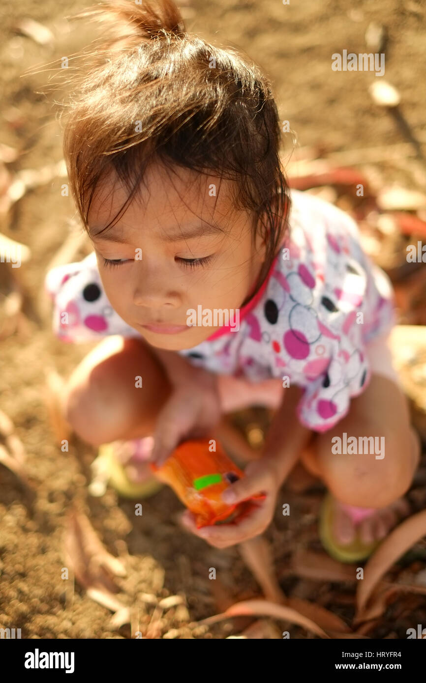 Little girl portrait with the sunlight sitting on the ground Stock ...