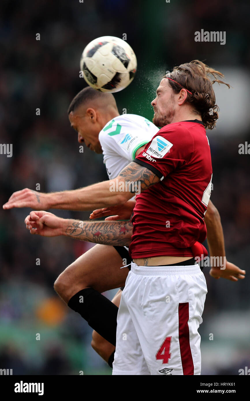 Fuerth, Germany. 5th Mar, 2017. Fuerth's Mathis Bolly (l) and Nuremberg's Dave Bulthuis in action during the 2nd Bundesliga soccer match between SpVgg Greuther Fuerth and 1. FC Nuremberg at the Stadion am Laubenweg in Fuerth, Germany, 5 March 2017. (EMBARGO CONDITIONS - ATTENTION: Due to the accreditation guidlines, the DFL only permits the publication and utilisation of up to 15 pictures per match on the internet and in online media during the match.) Photo: Daniel Karmann/dpa/Alamy Live News Stock Photo