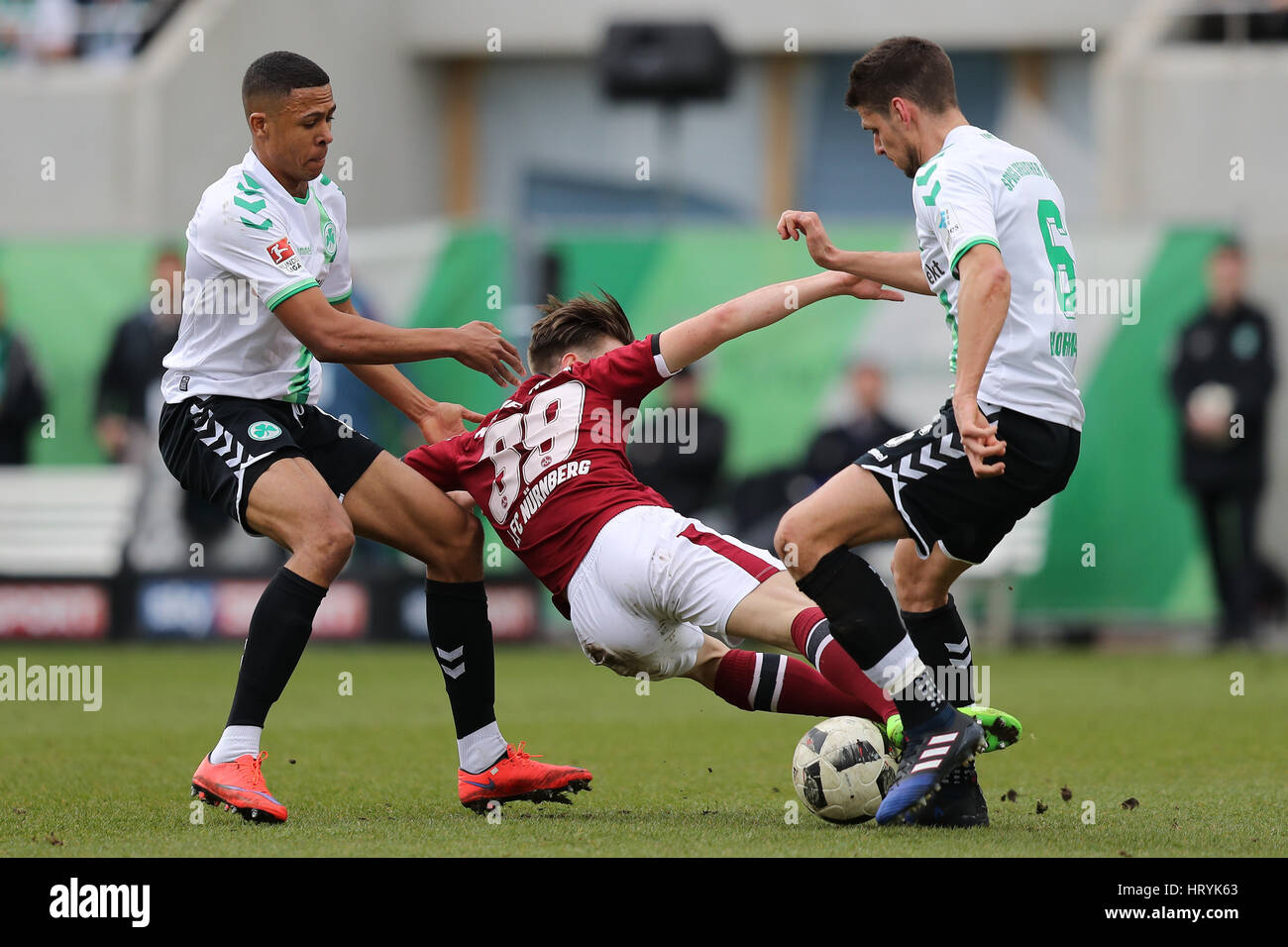 Fuerth, Germany. 5th Mar, 2017. Fuerth's Mathis Bolly (l) and Nuremberg's Andreas Hofmann (r) in action during the 2nd Bundesliga soccer match between SpVgg Greuther Fuerth and 1. FC Nuremberg at the Stadion am Laubenweg in Fuerth, Germany, 5 March 2017. (EMBARGO CONDITIONS - ATTENTION: Due to the accreditation guidlines, the DFL only permits the publication and utilisation of up to 15 pictures per match on the internet and in online media during the match.) Photo: Daniel Karmann/dpa/Alamy Live News Stock Photo