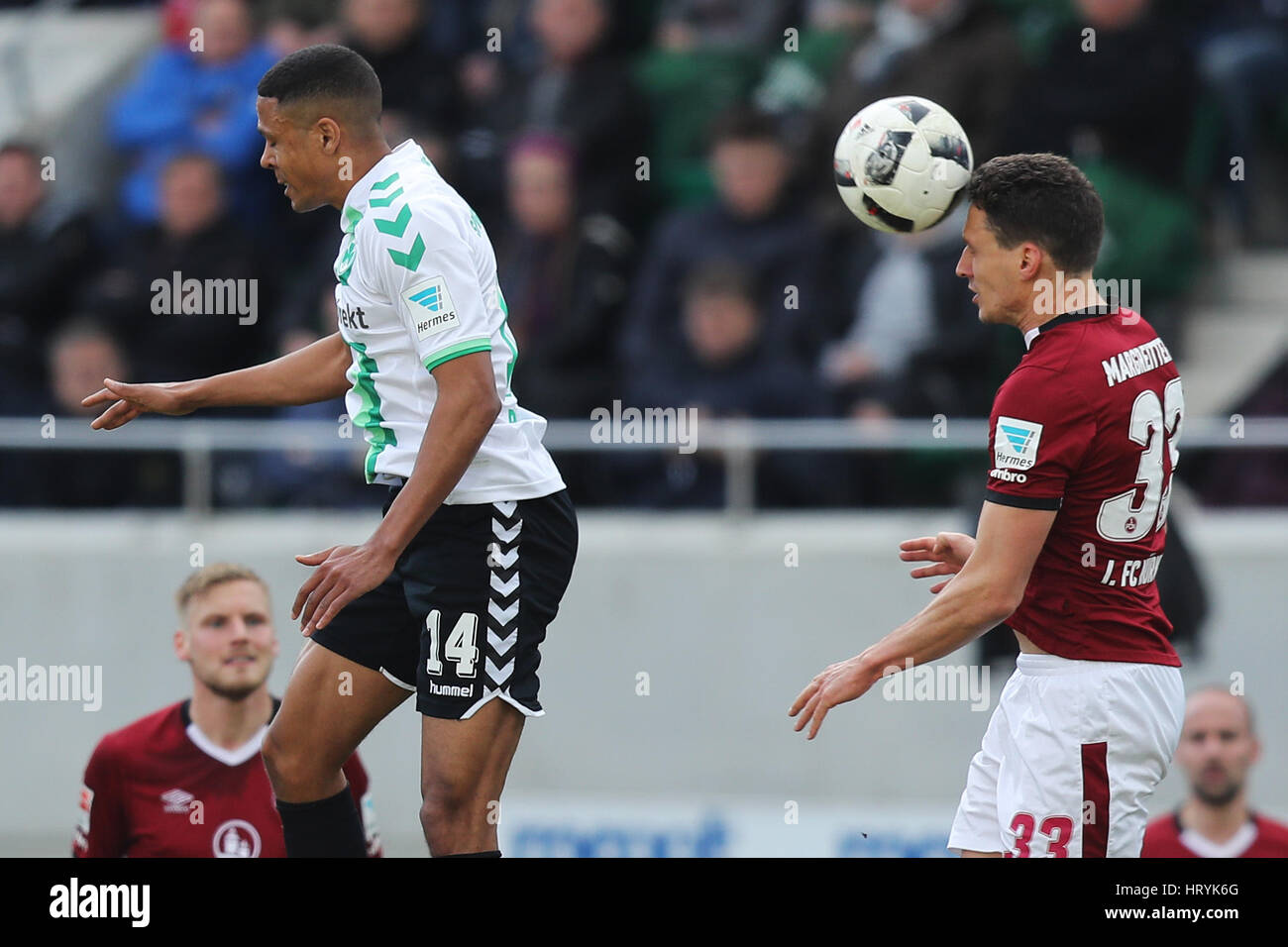 Fuerth, Germany. 5th Mar, 2017. Fuerth's Mathis Bolly (l) and Nuremberg's Georg Margreitter in action during the 2nd Bundesliga soccer match between SpVgg Greuther Fuerth and 1. FC Nuremberg at the Stadion am Laubenweg in Fuerth, Germany, 5 March 2017. (EMBARGO CONDITIONS - ATTENTION: Due to the accreditation guidlines, the DFL only permits the publication and utilisation of up to 15 pictures per match on the internet and in online media during the match.) Photo: Daniel Karmann/dpa/Alamy Live News Stock Photo