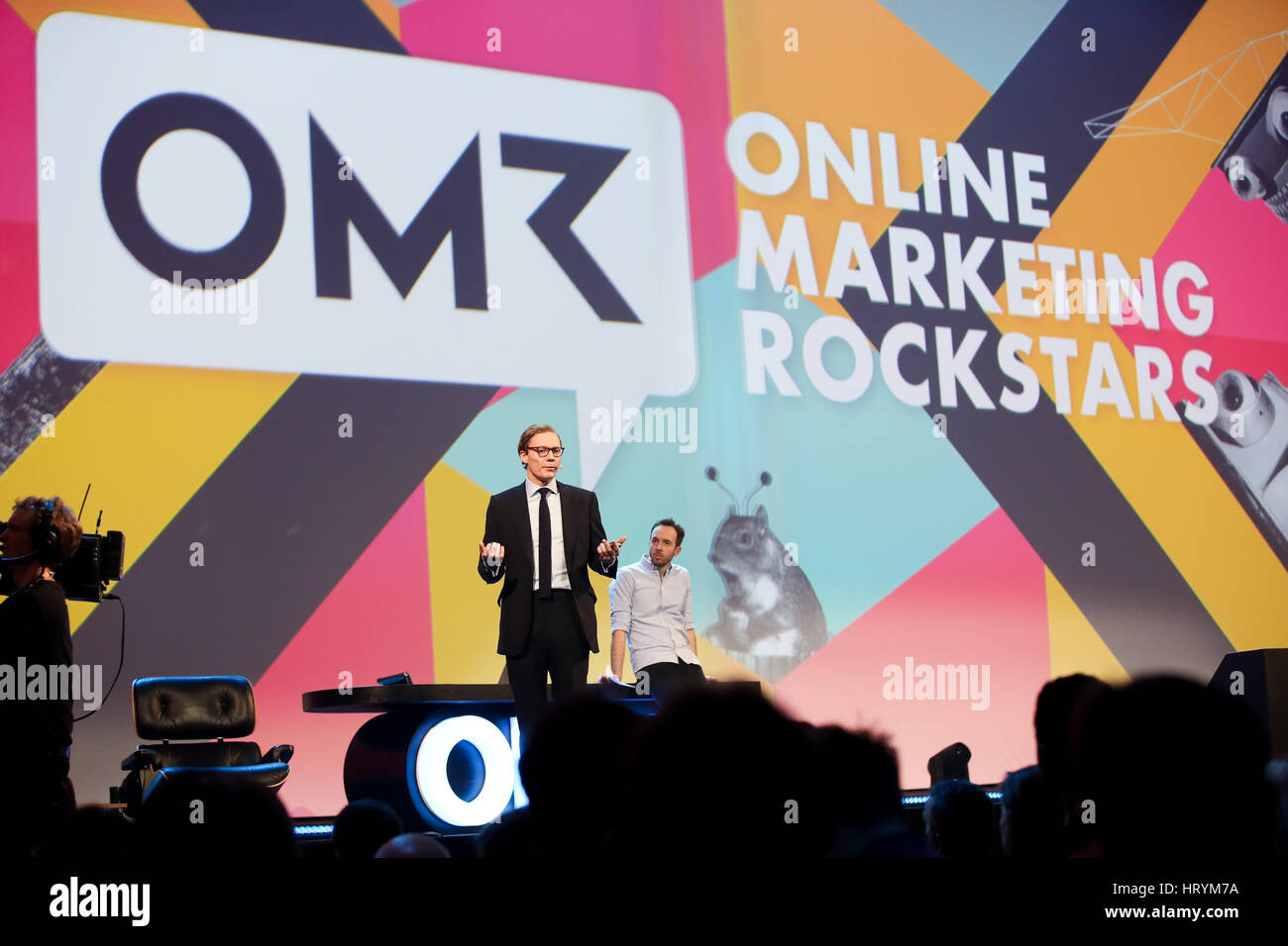 Data expert Alexander Nix (l), CEO of Cambridge Analytica, speaks next to OMR organiser Philipp Westermeyer at the marketing fair 'Online Marketing Rockstars' (OMR) in Hamburg, Germany, 3 March 2017. Photo: Christian Charisius/dpa Stock Photo