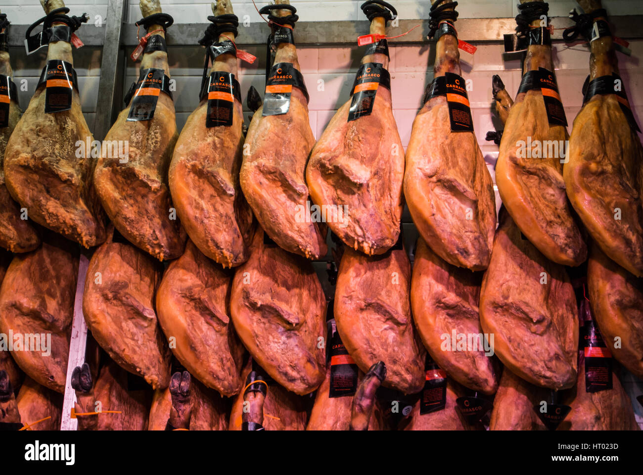 MADRID, SPAIN - FEBRUARY 12, 2017: Ham legs at San Miguel Market at Madrid, Spain. Stock Photo
