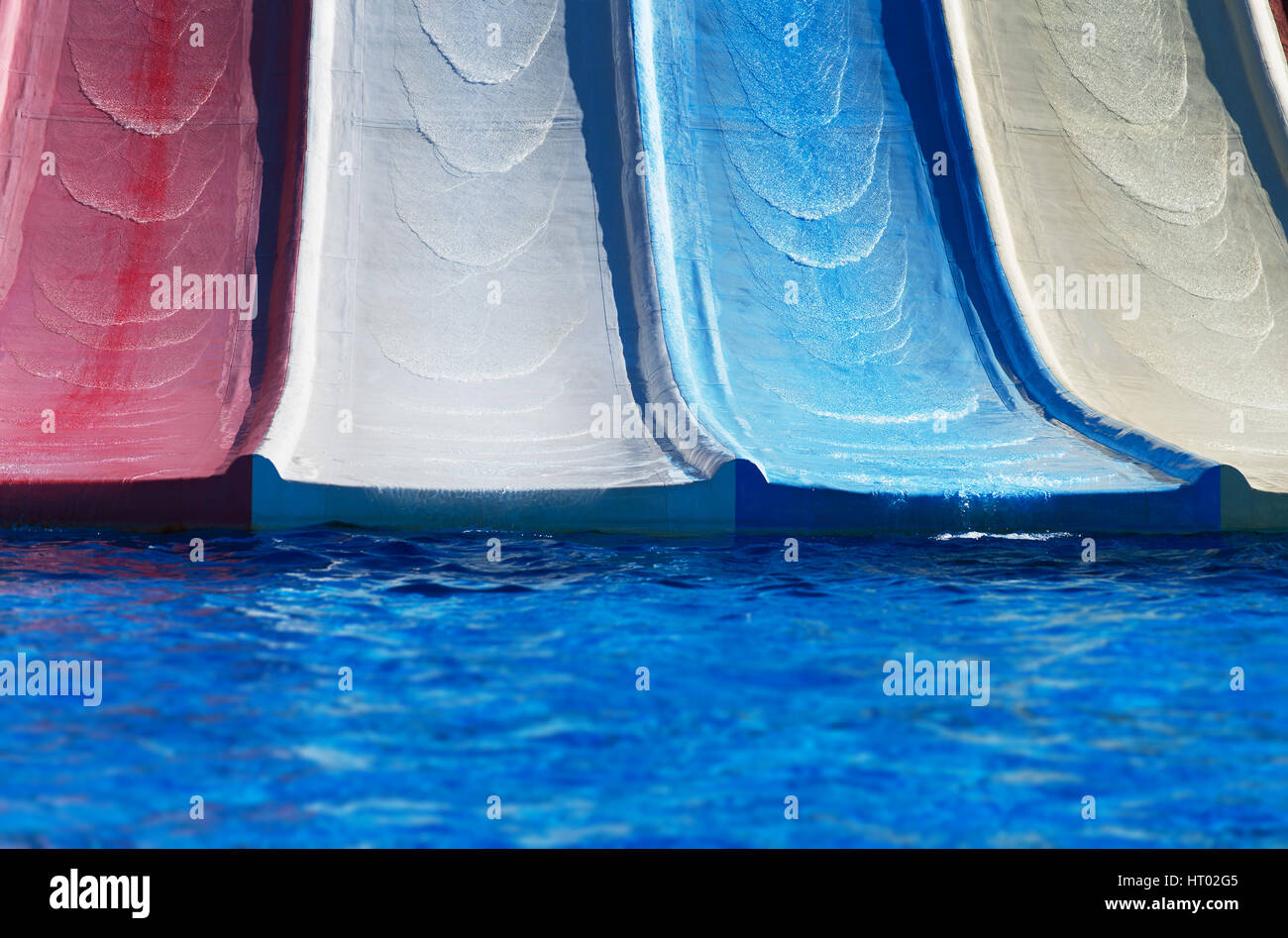 Colorful plastic water-slides in aqua park. Stock Photo