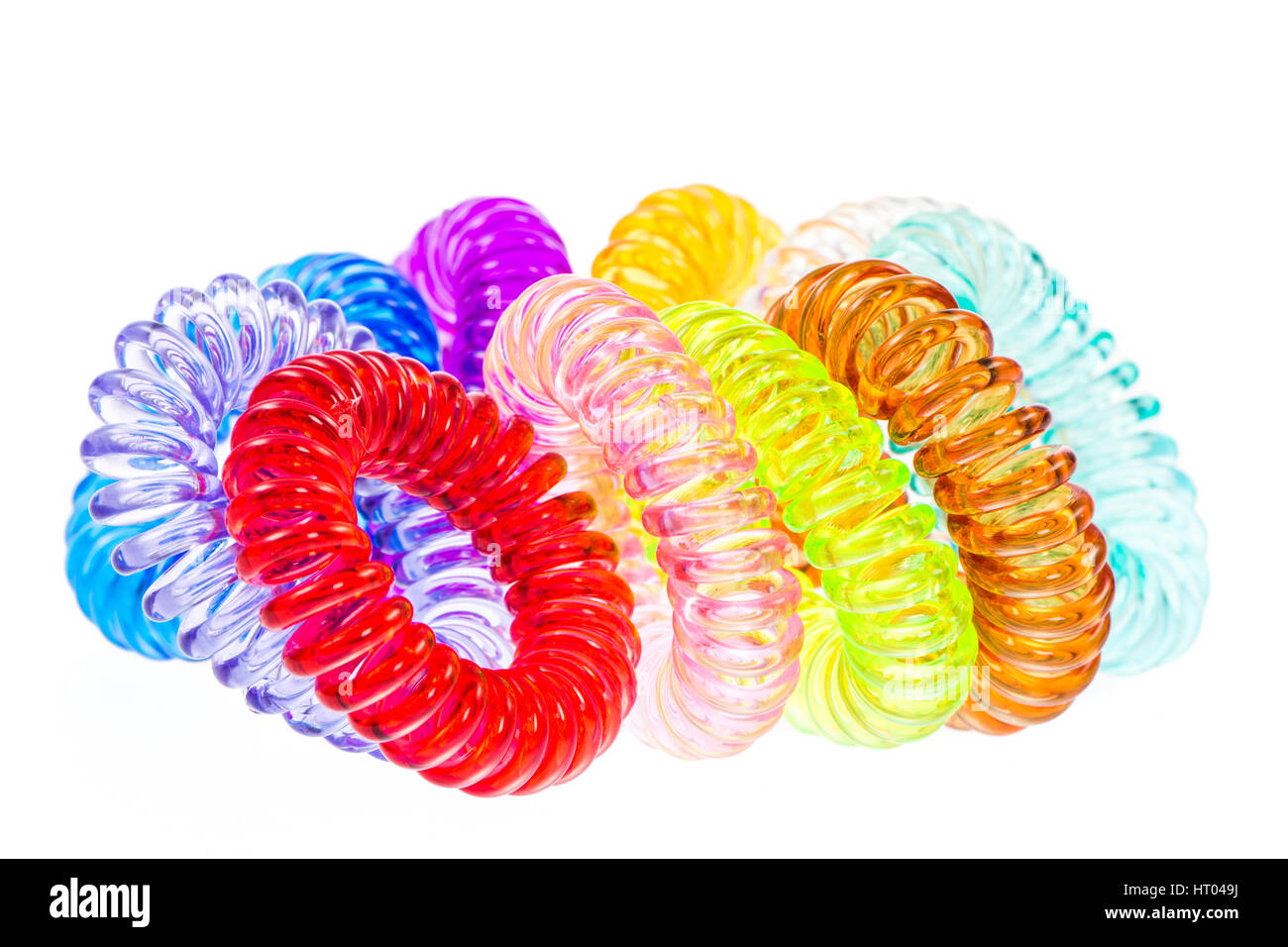 Closeup of various isolated spiral hair ties Stock Photo