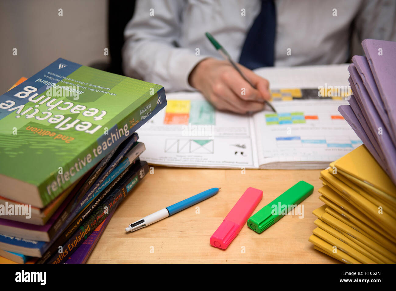 A primary school teacher marking a pupil's English homework. Stock Photo