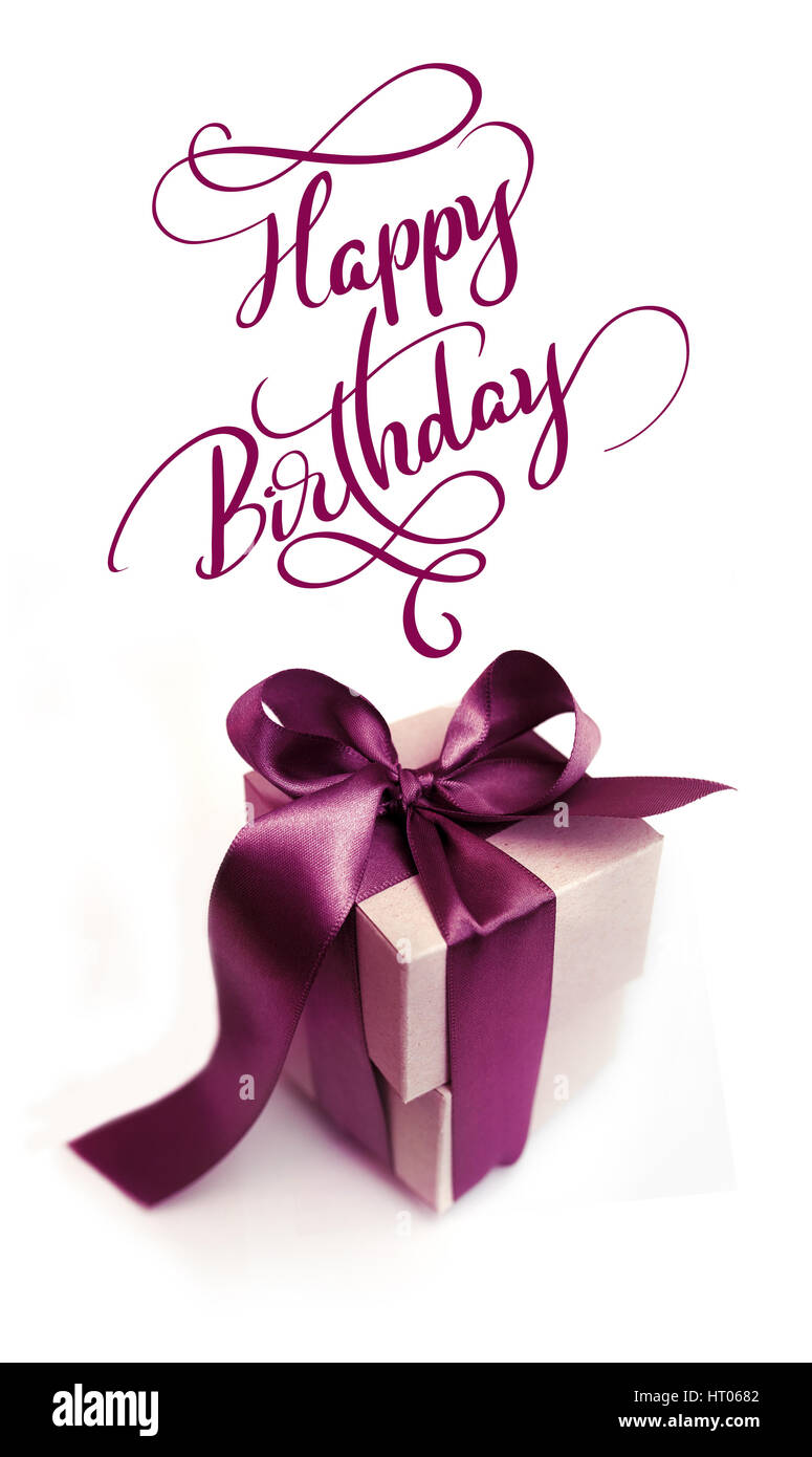 Gift boxes with brown bow on a white background and text Happy Birthday. Calligraphy lettering Stock Photo