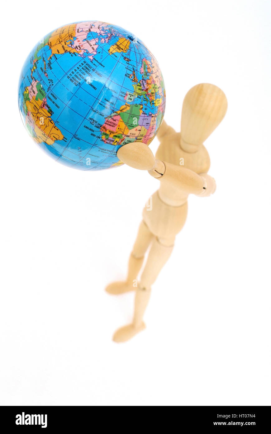 Holzfigur haelt Globus in der Hand - jointed doll with globe in hands Stock Photo