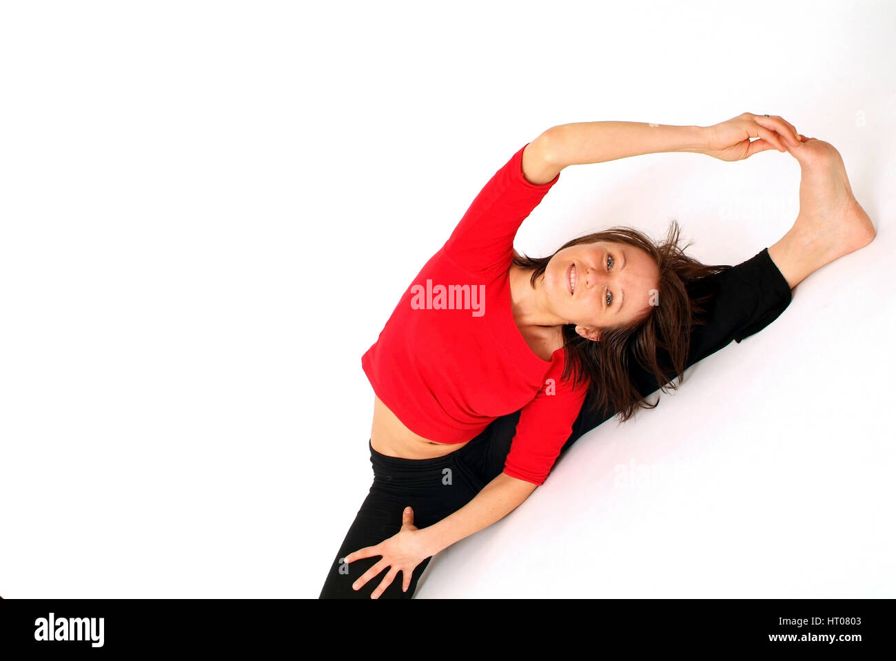Junge Frau beim Dehnen - young woman does stretching Stock Photo