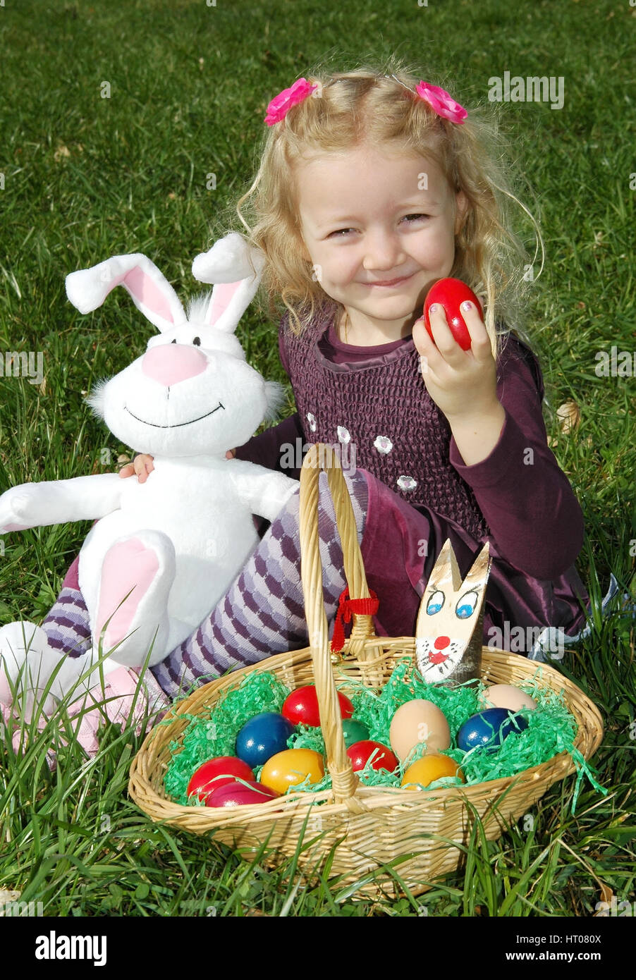 Maedchen mit Osternest in der Wiese - girl with Easter nest in meadow Stock Photo