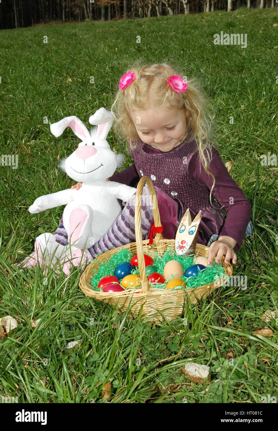 Maedchen mit Osternest in der Wiese - girl with Easter nest in meadow Stock Photo