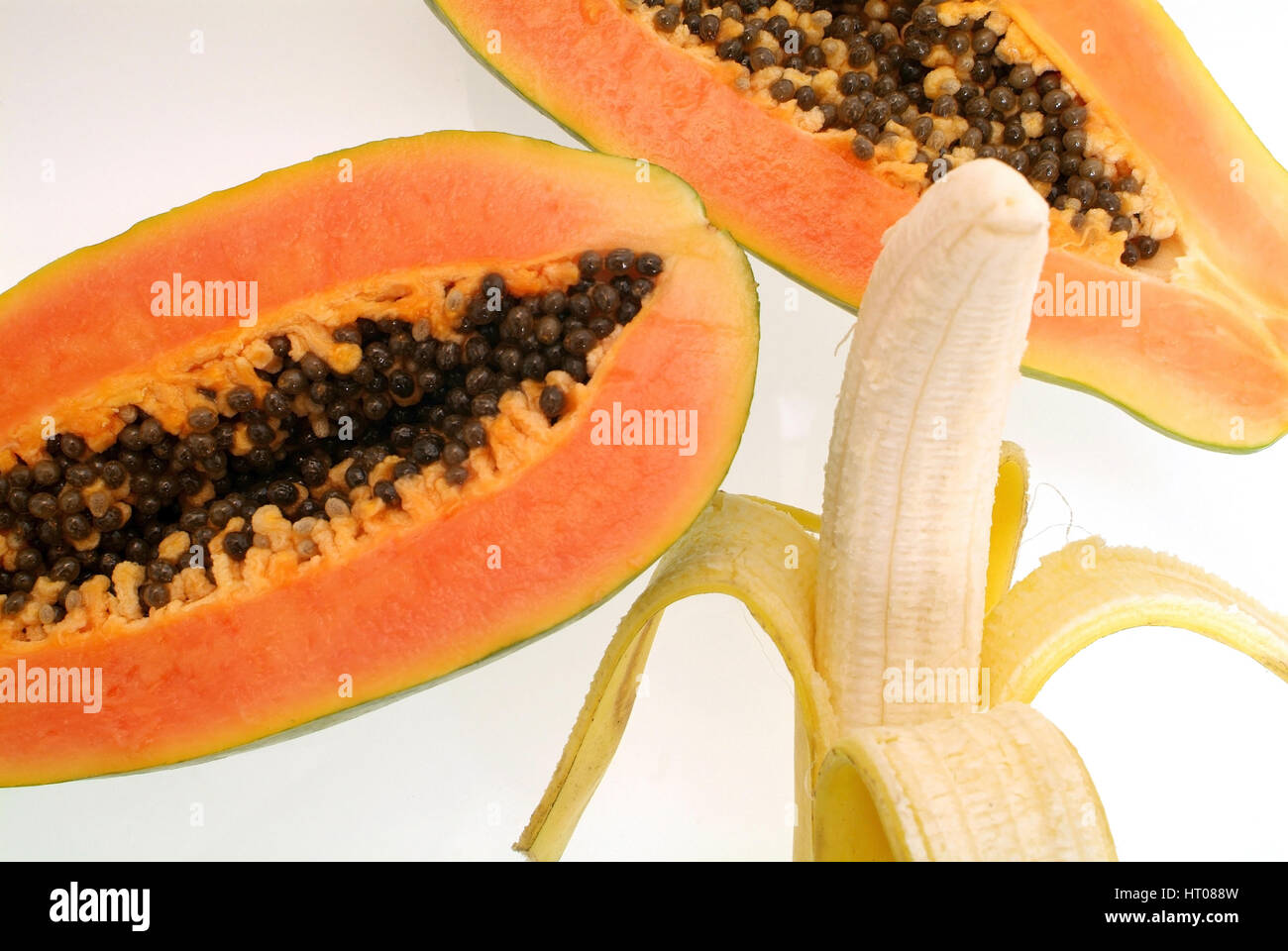 aufgeschnittene Papaya und geschaelte Banane - sliced papaya and peeled banana Stock Photo