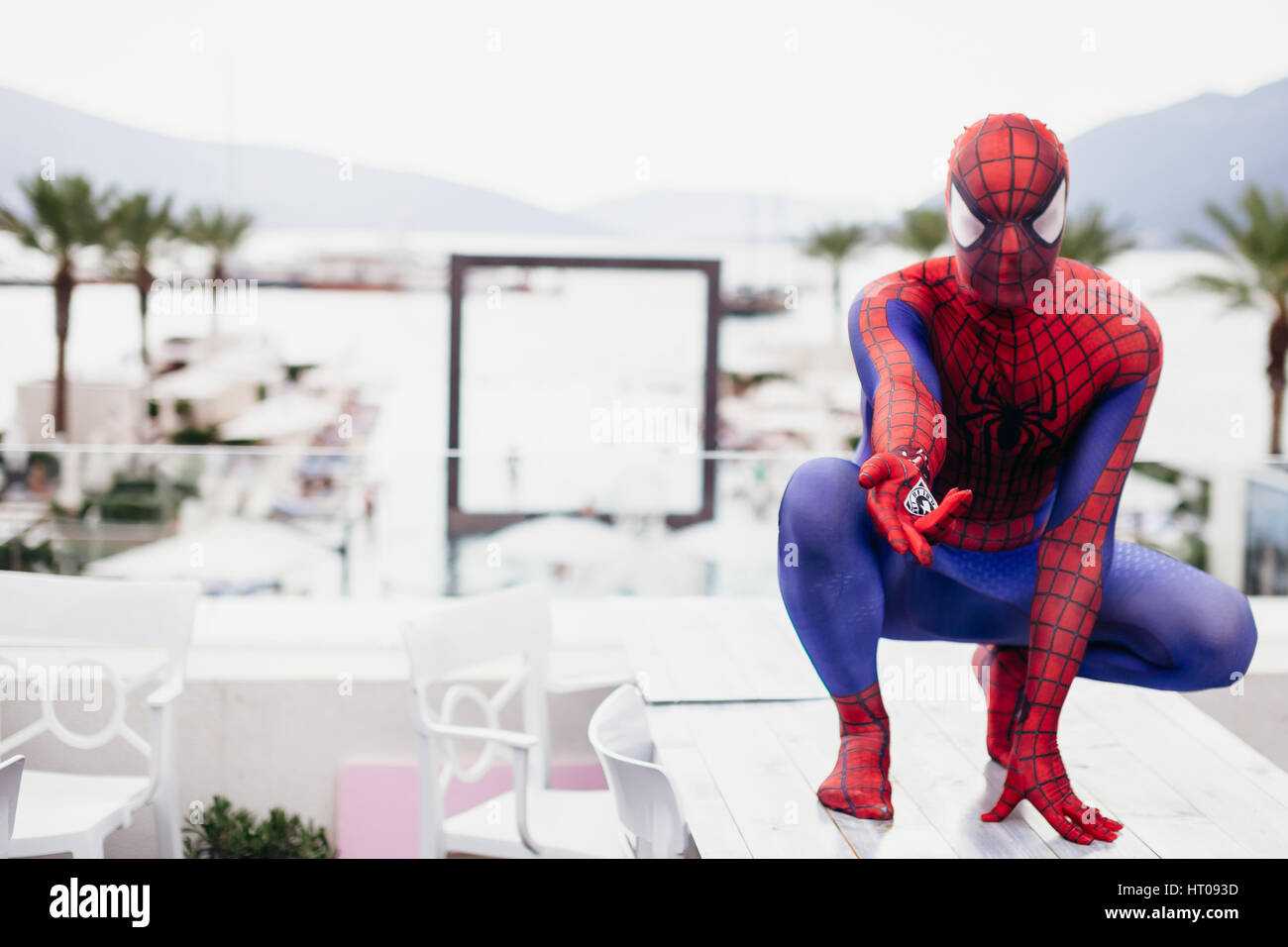 TIVAT, MONTENEGRO - AUG 4, 2015:  Cosplayer dressed as Spiderman in cafe of TIvat. Spider man is a fictional character created by Stan Lee Stock Photo