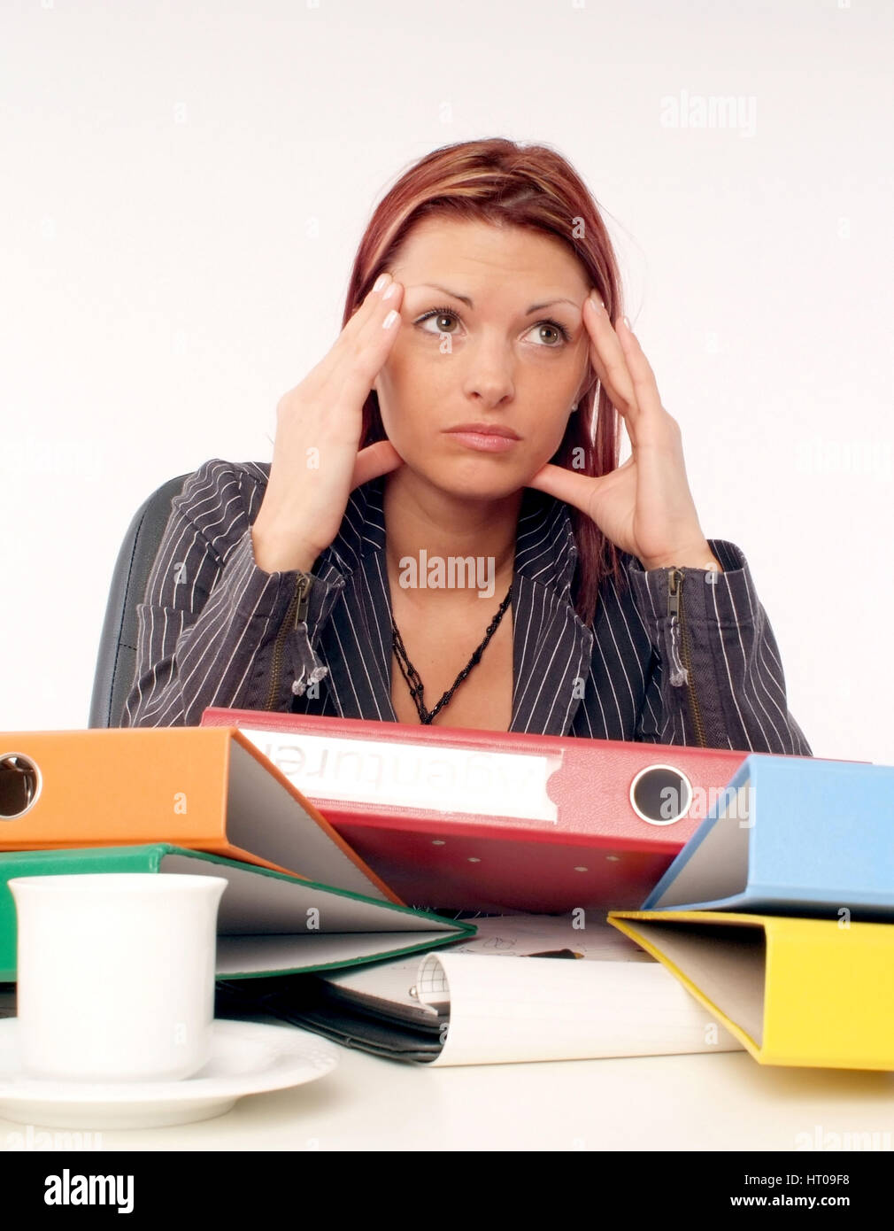 Gestresste, ueberforderte Geschaeftsfrau am Schreibtisch - stressed, overcharged businesswoman at the office Stock Photo