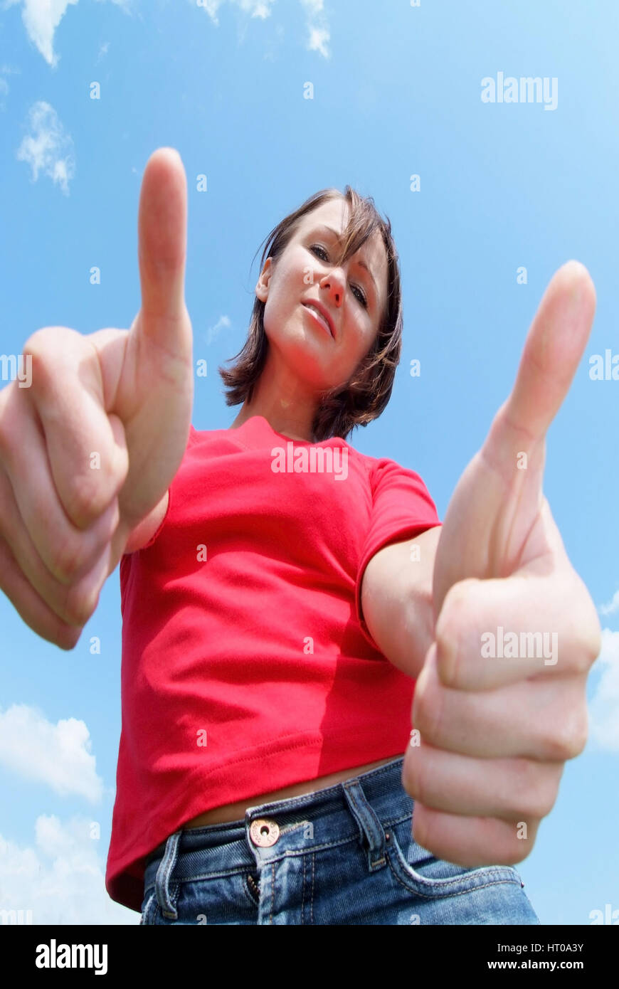 'Junge, zuversichtliche, selbstbewusste Frau mit ''Daumen hoch'' - young, confident woman with thumbs up' Stock Photo