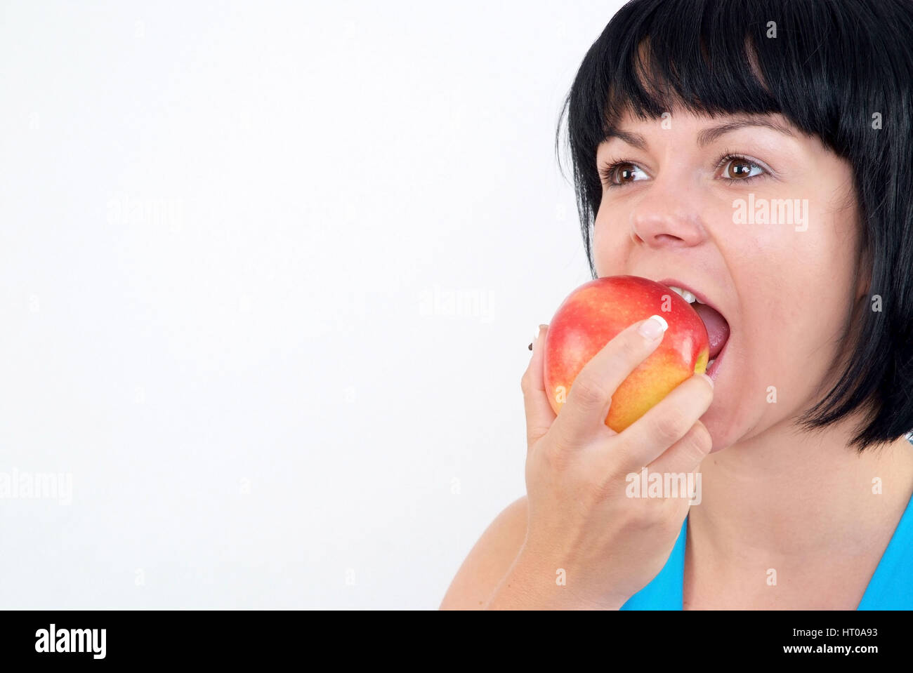 Frau isst Apfel - woman eats apple Stock Photo