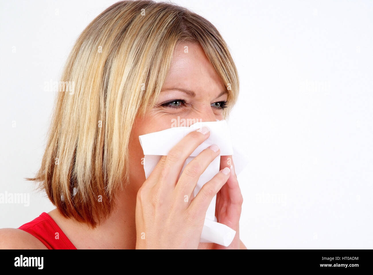 Frau schneuzt sich - woman blows her nose Stock Photo