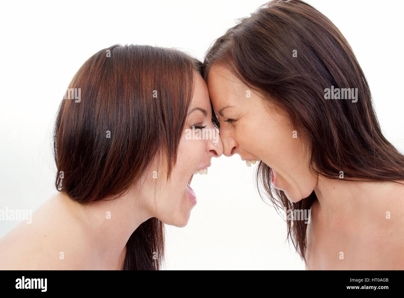 Zwillinge schreien sich an - twins screaming each other Stock Photo