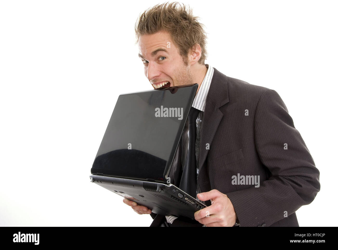 Gesch‰ftsmann bei?t in Laptop - business man bites in laptop Stock Photo
