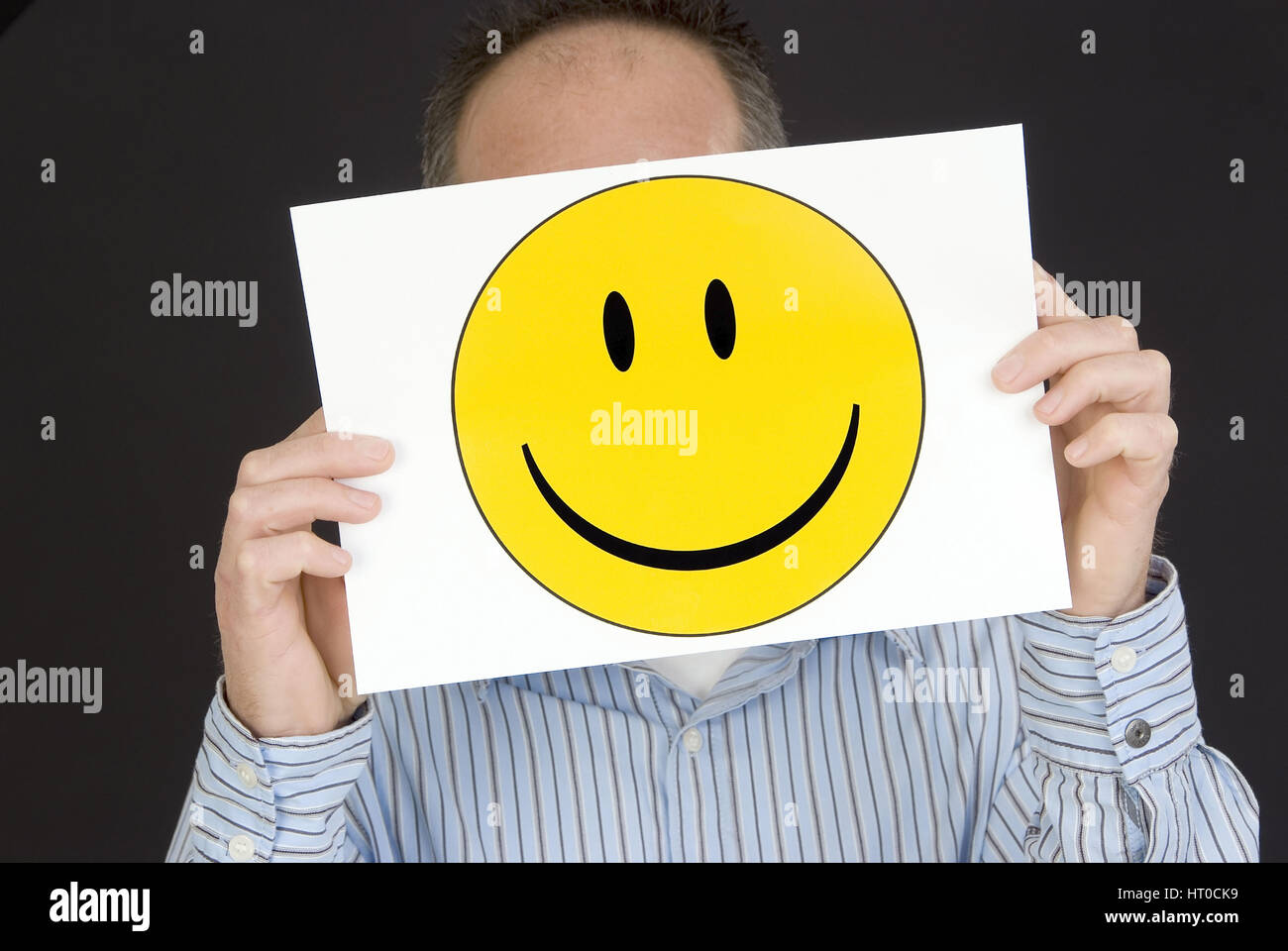 Mann mit lachendem Smileygesicht - man with laughing smiley face Stock Photo