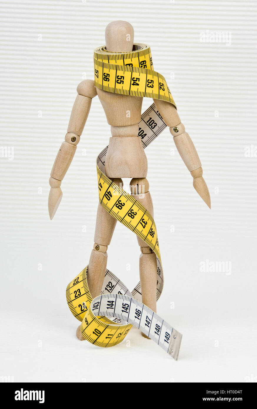 Gliederpuppe mit Ma?band umwickelt - jointed doll wound in a measuring tape Stock Photo