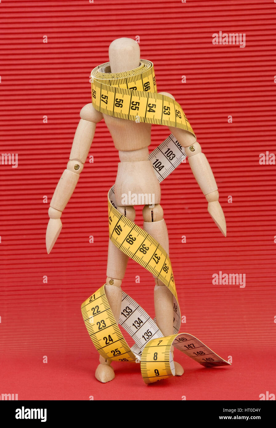 Gliederpuppe mit Ma?band umwickelt - jointed doll wound in a measuring tape Stock Photo