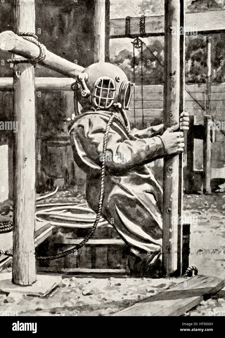 Diver descending to work under the Walls of Winchester Cathedral, circa 1900 Stock Photo