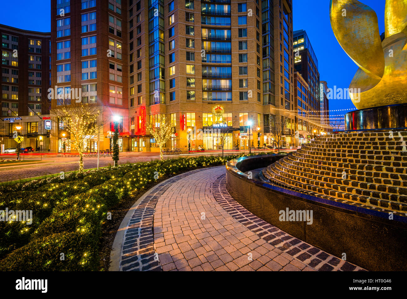 The National Katyń Memorial and modern buildings at night, in Harbor East, Baltimore, Maryland. Stock Photo