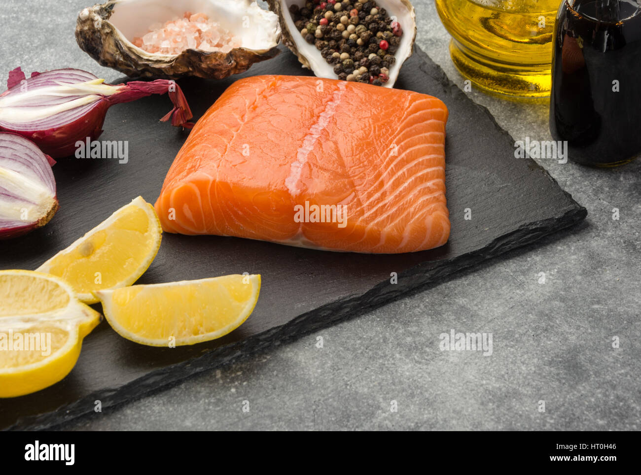 Ingredients for tar-tare sauce from a salmon, rich in omega 3 oil, with  aromatic herbs and spices with a lemon, tomato, garlic on black background.  He Stock Photo - Alamy