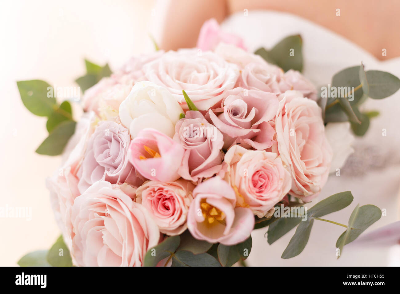 Brides bouquet of roses, tulips and eucalyptus Stock Photo