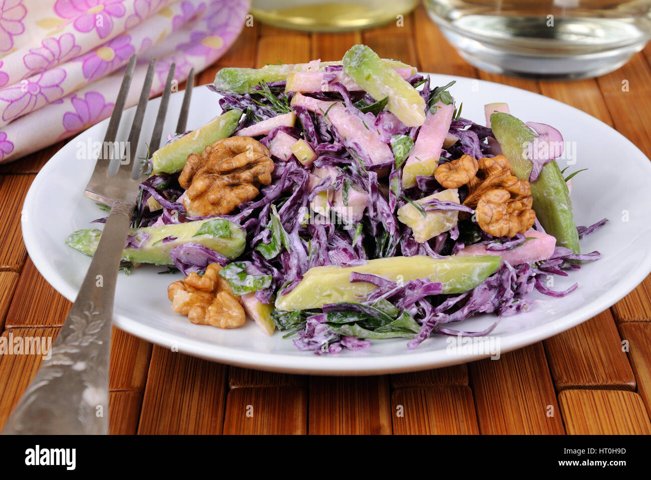 salad red coleslaw with slices of avocado, apple, nuts, parsley, dill