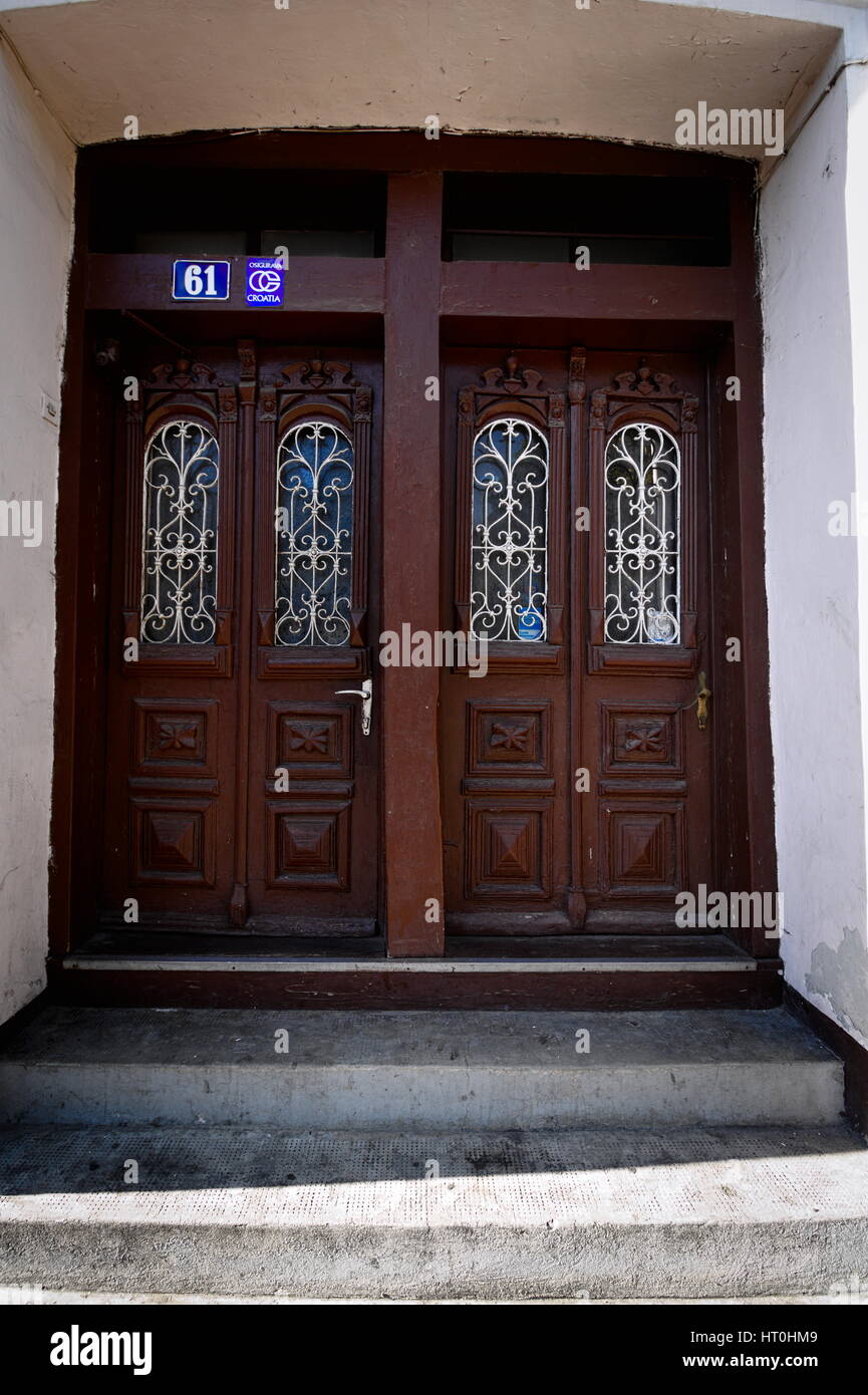 Elaborate old wooden door way with twin doors in Otocac, Croatia Stock Photo