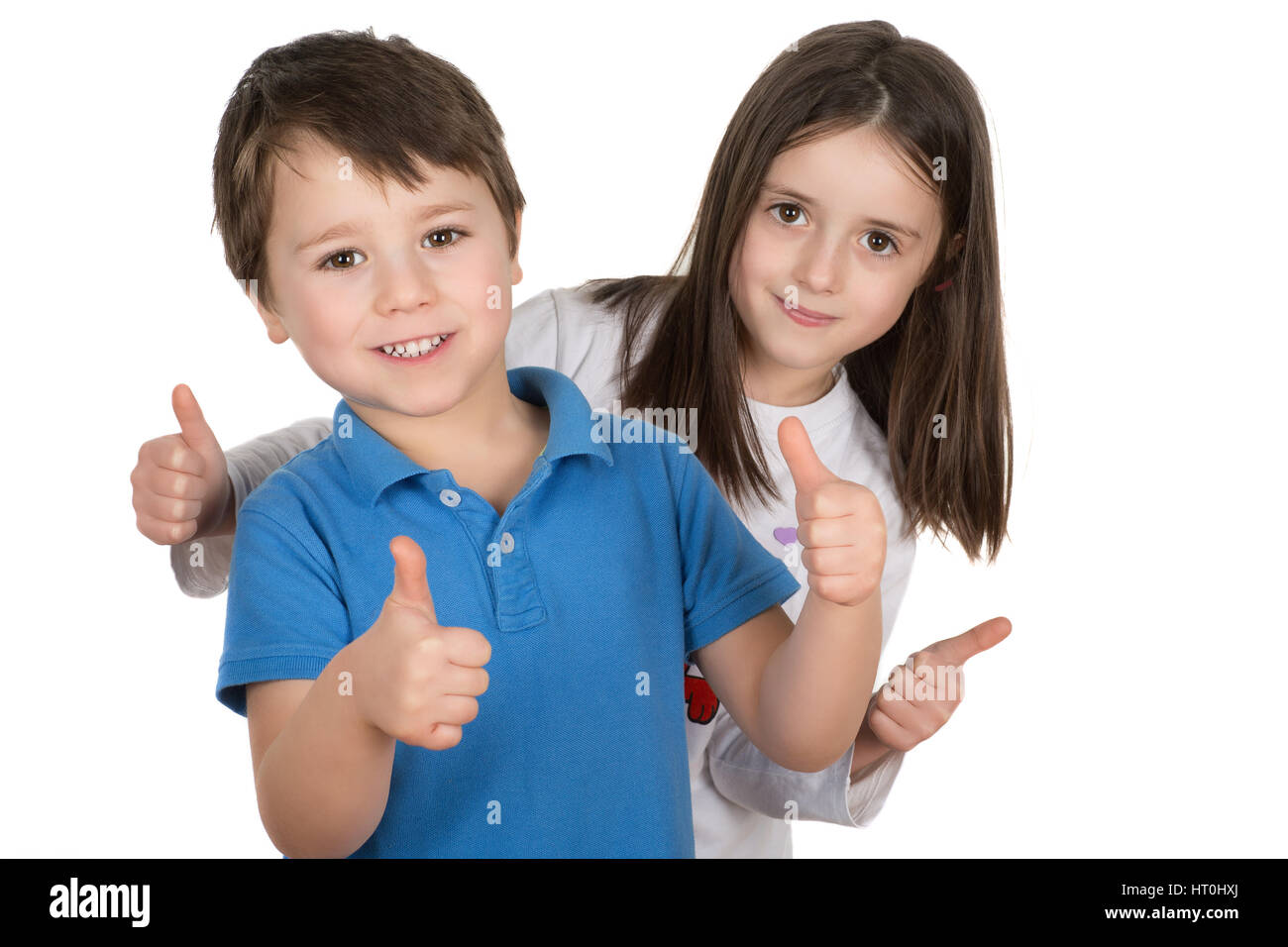 Happy boy and a girl smiling with thumbs up. Isolated on a white background. Stock Photo