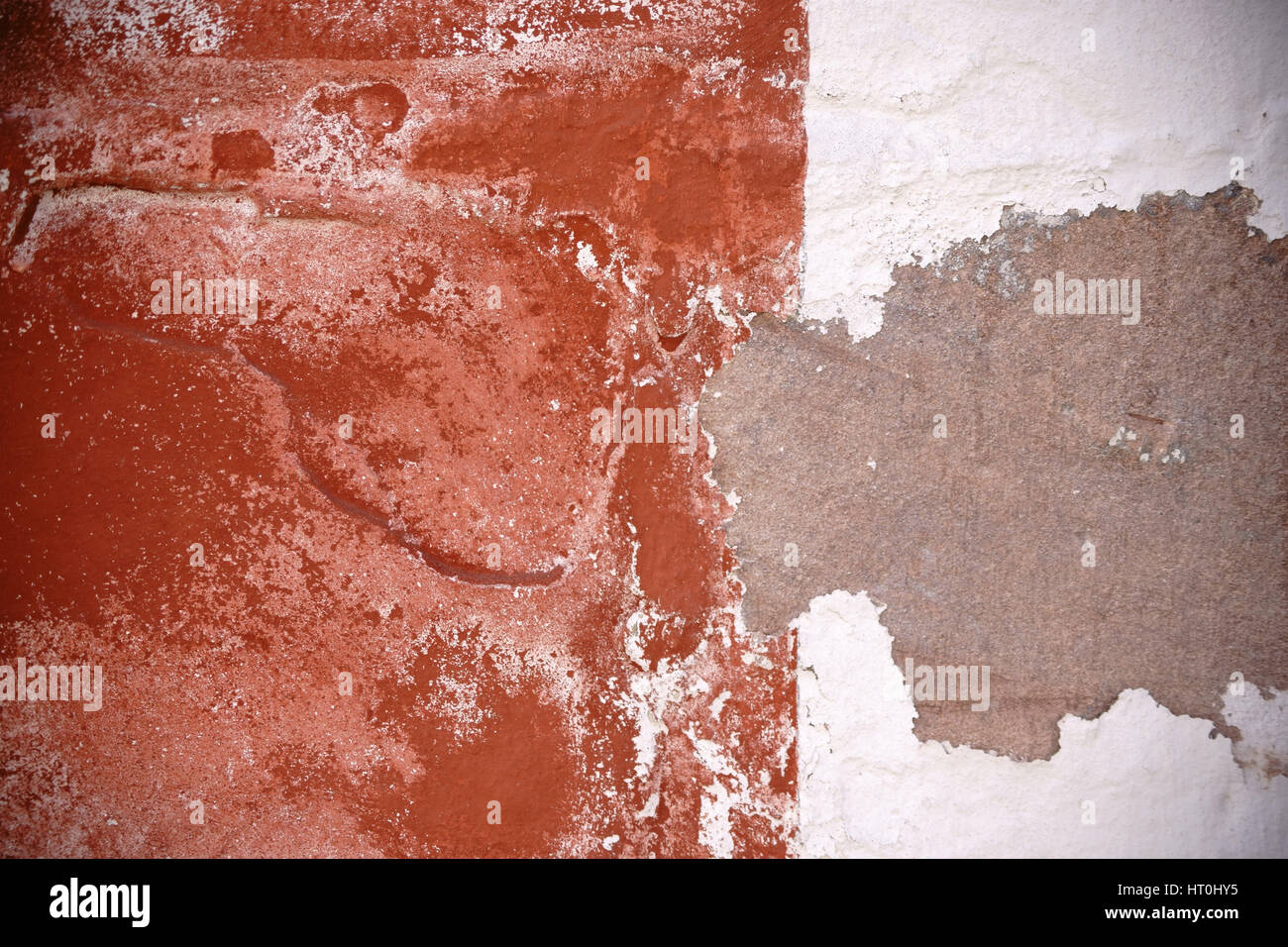 The close up of a wall with a chipped plaster layer. Stock Photo