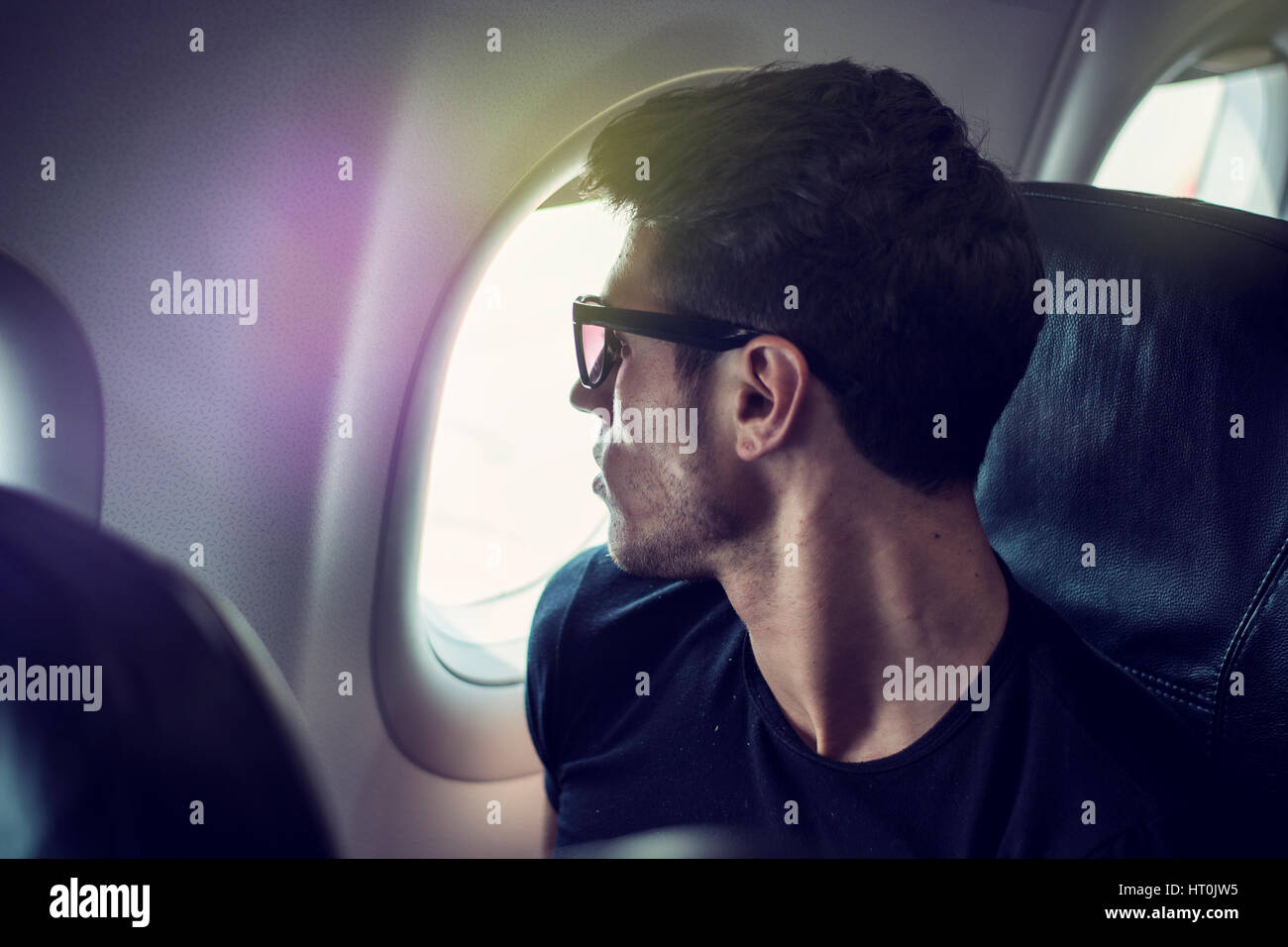 Young man in plane Stock Photo