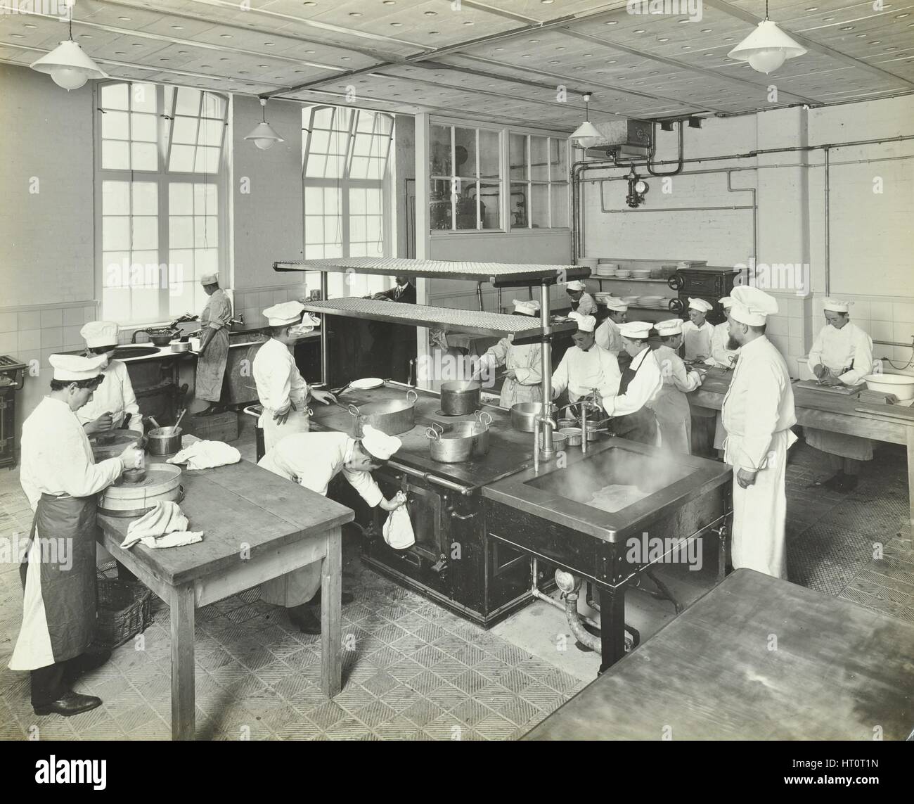 Male cookery students at work in the kitchen, Westminster Technical Institute, London, 1910. Artist: Unknown. Stock Photo